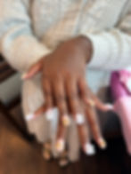 Woman showing manicured nails at a mobile press on nail party