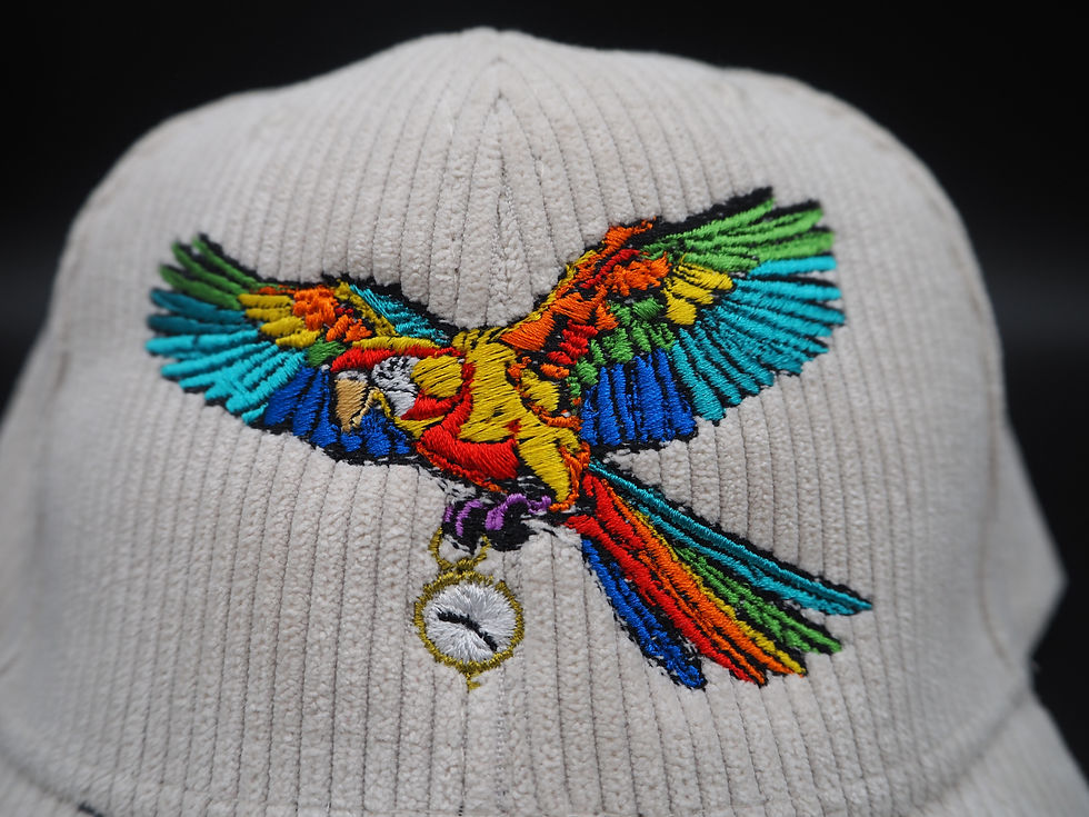 Detailed View of Embroidery; parrot with wings outstretched clutching clock with feet.