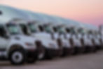 Eye-level view of a line of International trucks parked at a dealership
