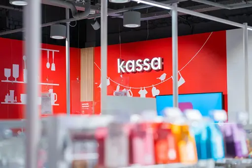 HEMA store interior with bold red checkout area and branded retail signage as part of the new store concept