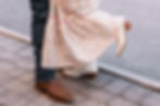 Couple's legs embracing, one lifted in a candid moment.