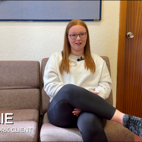 Routes to Work client and school leaver Charlie sitting on a seat in our Craigneuk office in North Lanarkshire. She is telling her story about how she received employability support that helped her landed a job in the construction industry as a painter and decorator