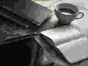 Blogging with tablet, notebooks, and coffee