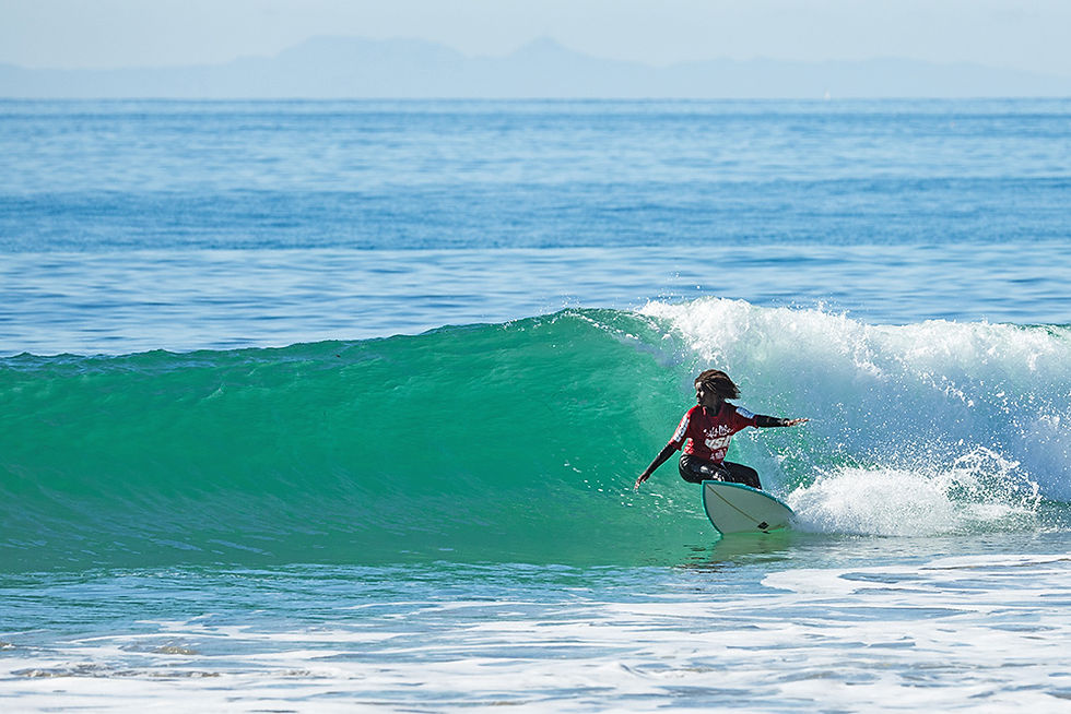 Maizy Gordon going backside prepping for a huge snap during a surf competition, Local Break Surf Magazine.