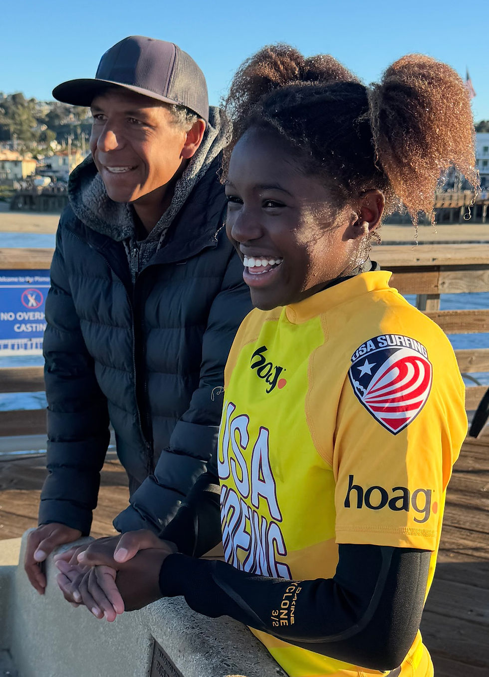 Maizy Gordon and her coach before a surf competition, Local Break Surf Magazine.