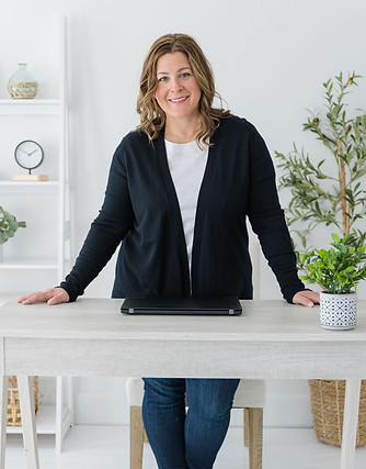 Denise Black and White standing at desk.jpg