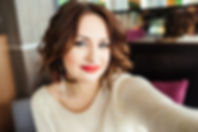 Selfie-portrait of cute brunette girl with short hair sitting at table on terrace in resta