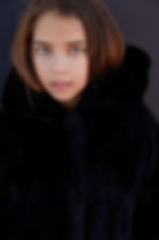 Ella Klein with dark background focusing on her piercing eyes