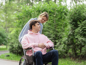 Participant and support worker enjoying time together in a park, showing how community access enhances NDIS respite outcomes.