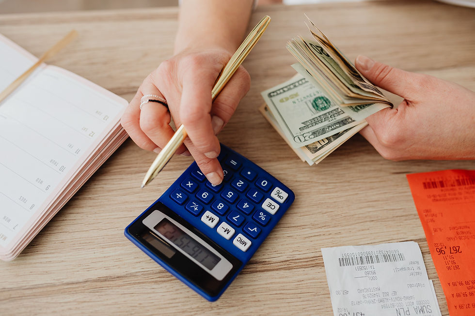 Hands using a calculator alongside cash, representing NDIS STA and respite pricing and budgeting.