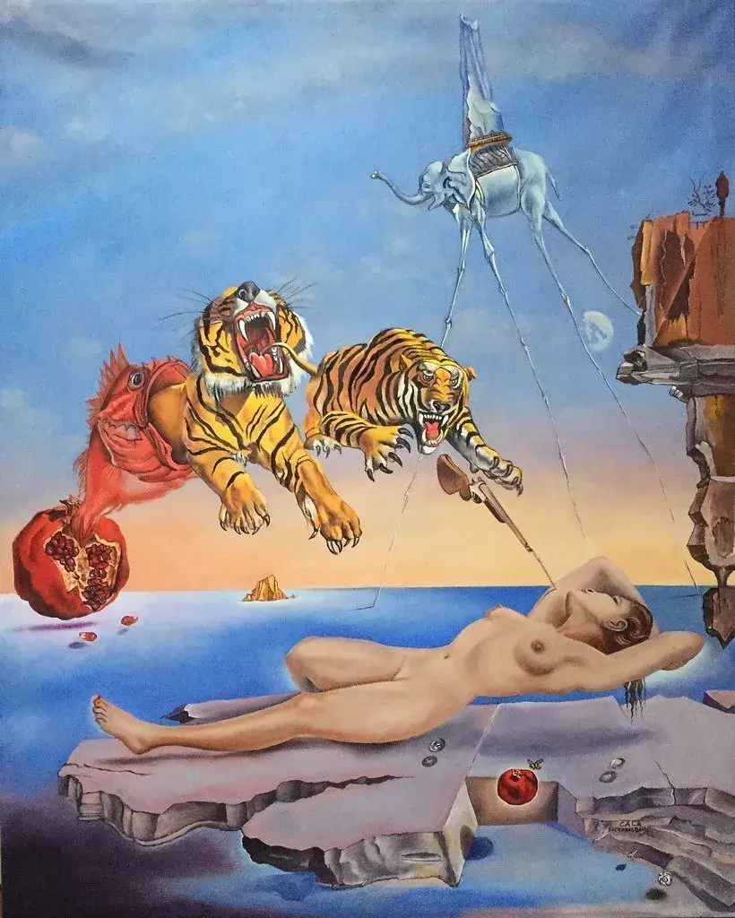 Il quadro "Sogno causato dal volo di unโape intorno a una melagrana un attimo prima del risveglio" di Salvador Dalรฌ: รจ ambientato in un contesto naturale, con un grande cielo all'alba e il mare con scogli e isolotti in lontananza. Nel cielo fluttua un elefante che trasporta sulla groppa quello che sembra una roccia triangolare, ha le quattro zampe lunghissime e sottili. A sinistra del quadro รจ raffigurato un frutto di melograno spaccato in due da cui fuoriesce un grosso pesce rosso e da qui due tigri dall'aria minacciosa e una bionetta che punta ad una donna nuda addormentata e sdraiata sulla roccia sottostante. Accanto a lei vi รจ un'altro frutto di melograno con accanto una piccola ape che vola.