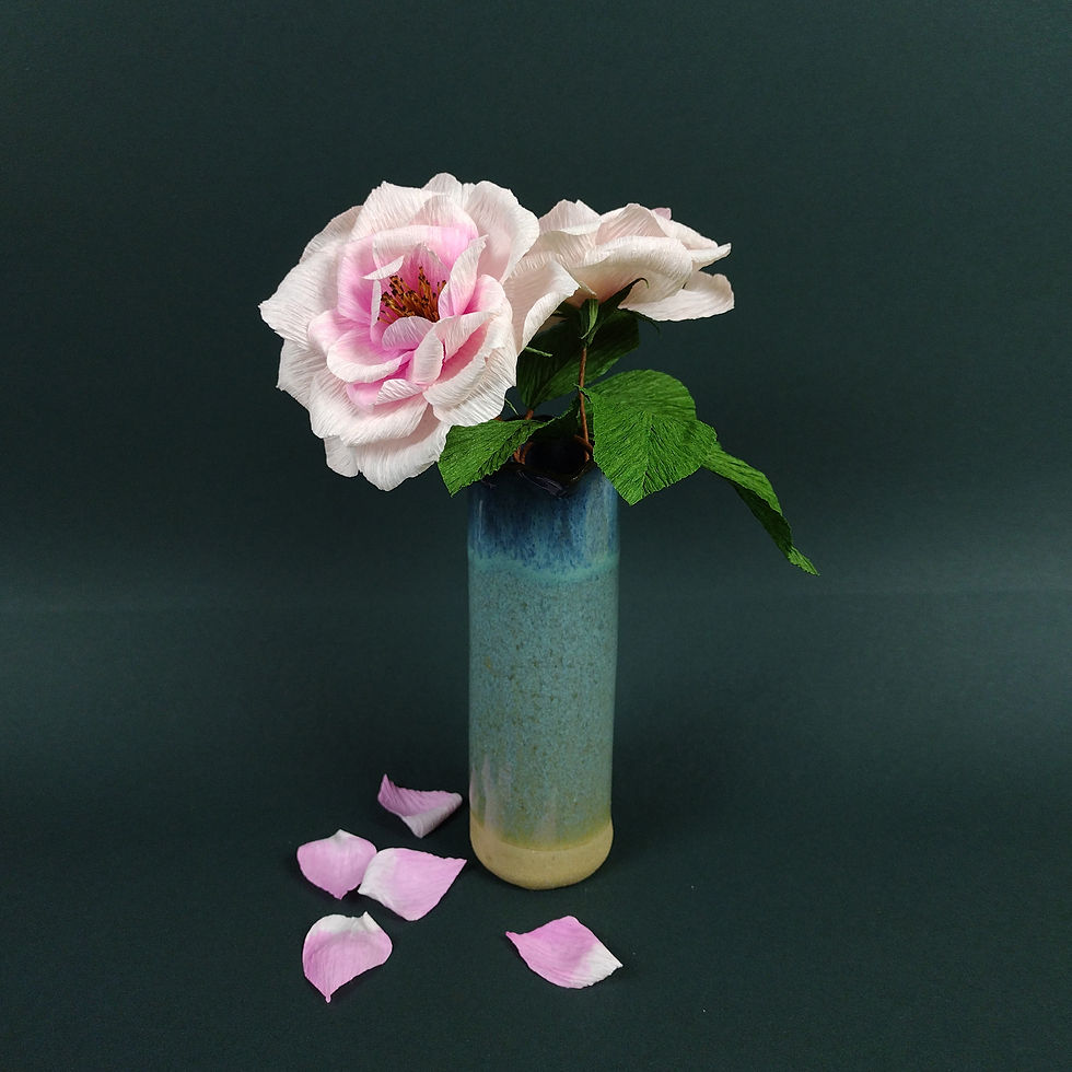 Thumbnail: Two paper open roses with leaves in a blue ceramic vase