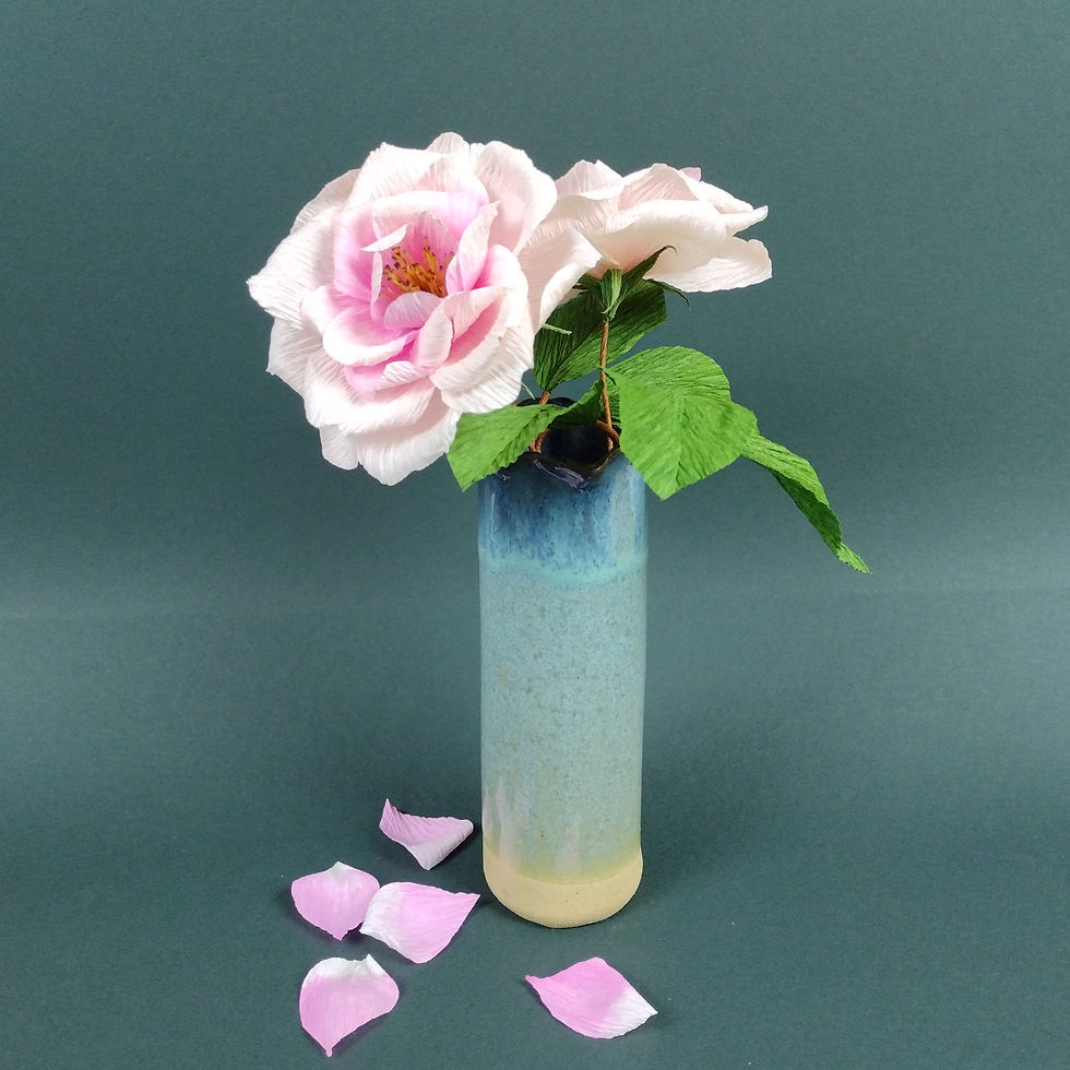 Thumbnail: Two paper open roses with leaves in a blue ceramic vase