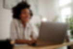 young-black-smiling-woman-working-at-computer-in-a-2022-02-01-22-37-26-utc_edited.jpg