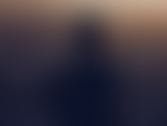 Silhouette of a person at sunset, with the sun casting a warm glow behind them.