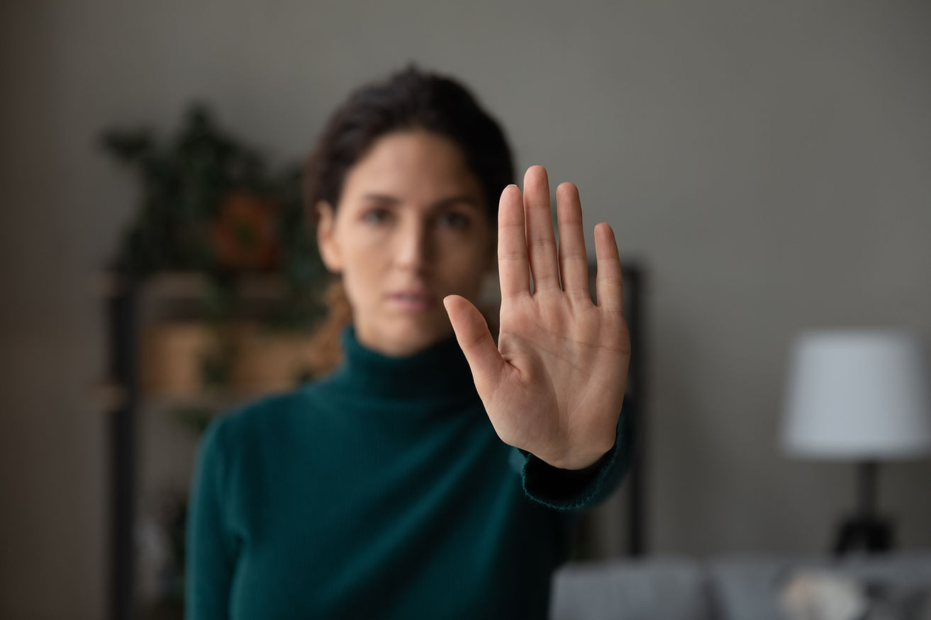 Crop close up of young Latino woman show no palm stop hand gesture against racial or gende