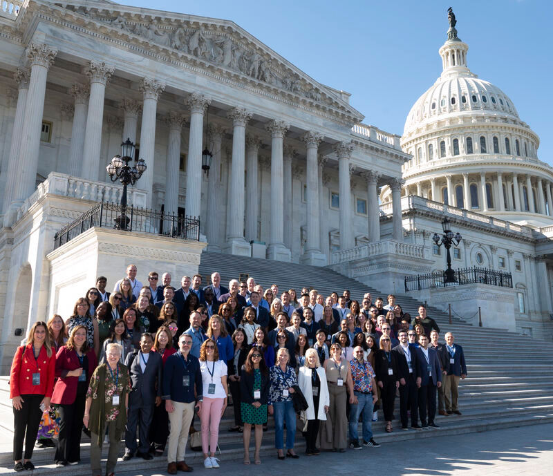 A group of 100 small business owners pose on the steps of the US Capitol, with current and former members of congress