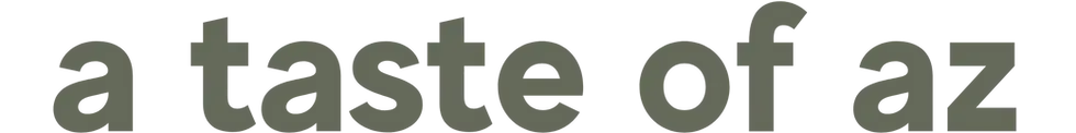 Gray lowercase text a taste of az on a black background, bold and cropped wide across the image.
