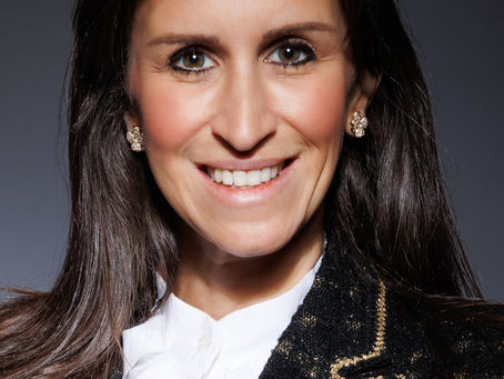 Professional headshot of a confident individual in business attire, photographed at Tals Studio in NYC with a clean studio background.