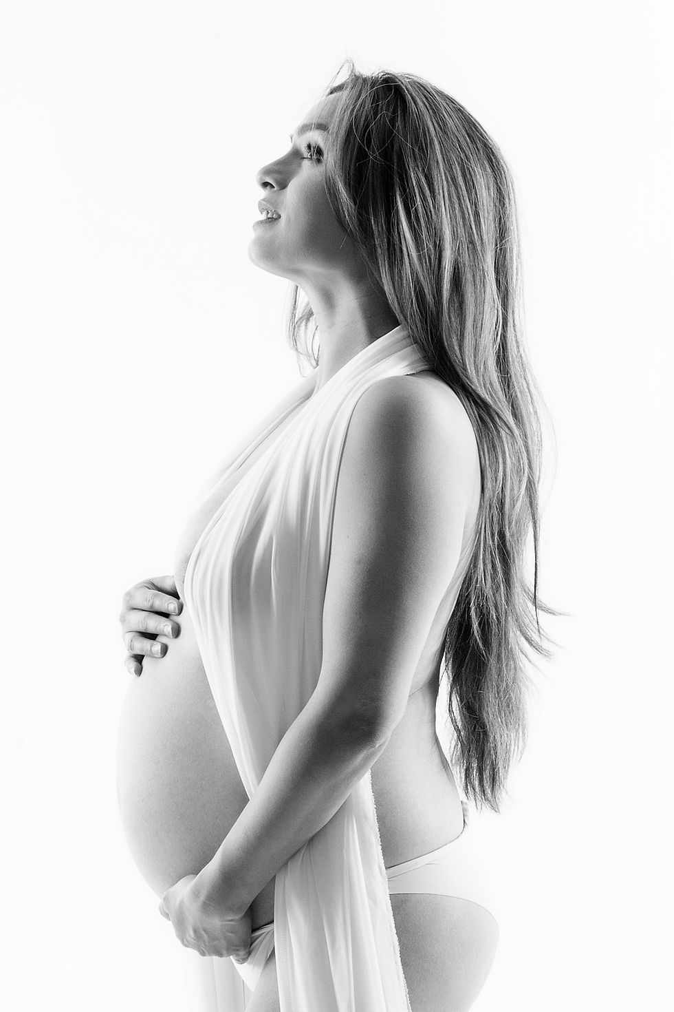 Pregnant woman posing in professional NYC maternity photoshoot