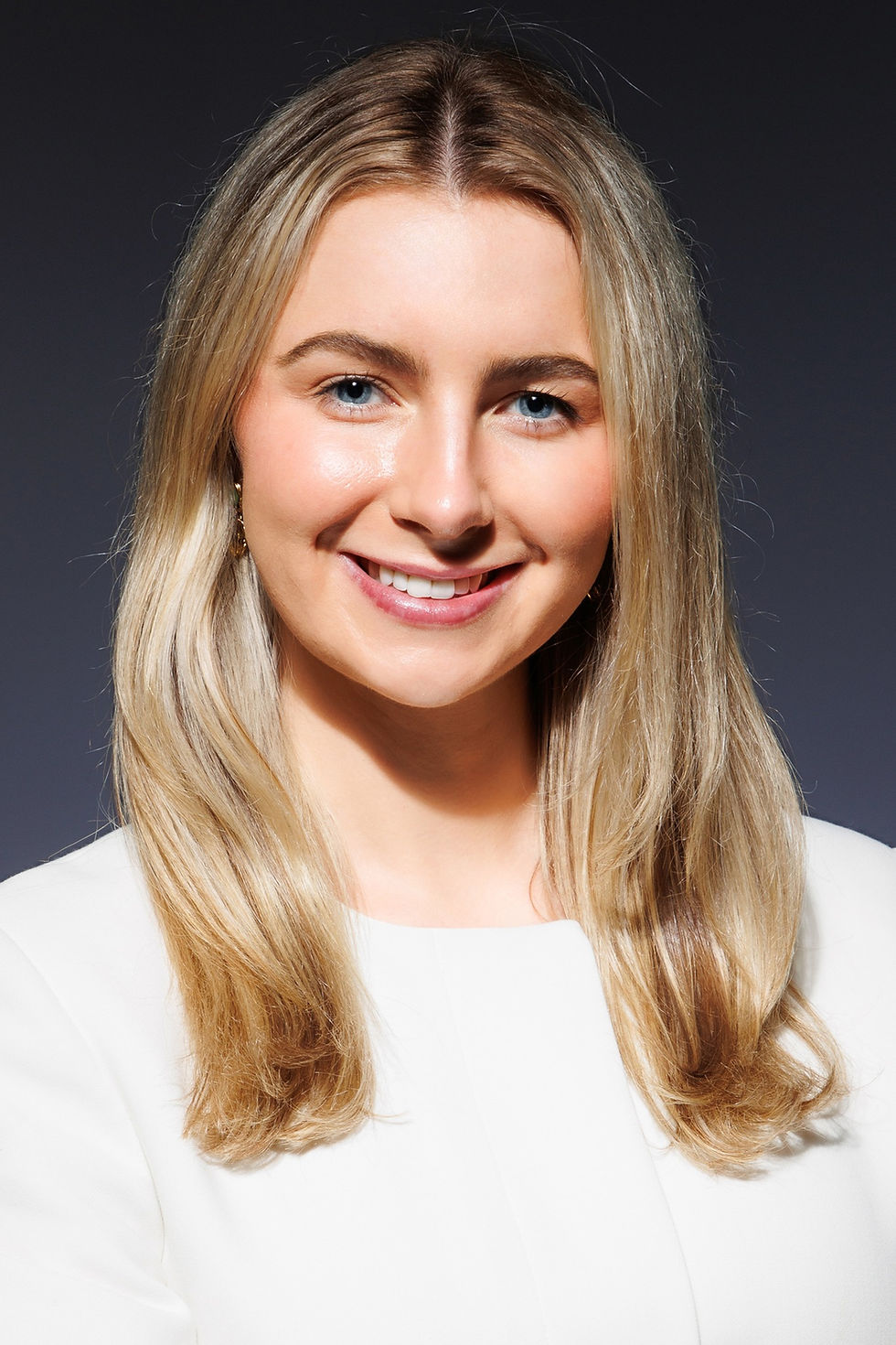 Photographer capturing a professional headshot of a client under studio lighting at Tals Studio NYC.
