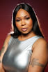 Confident woman posing in studio during affordable glamour shoot.