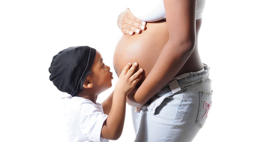 Family-friendly maternity photoshoot at Tals Studio, featuring parents and children in stunning portraits