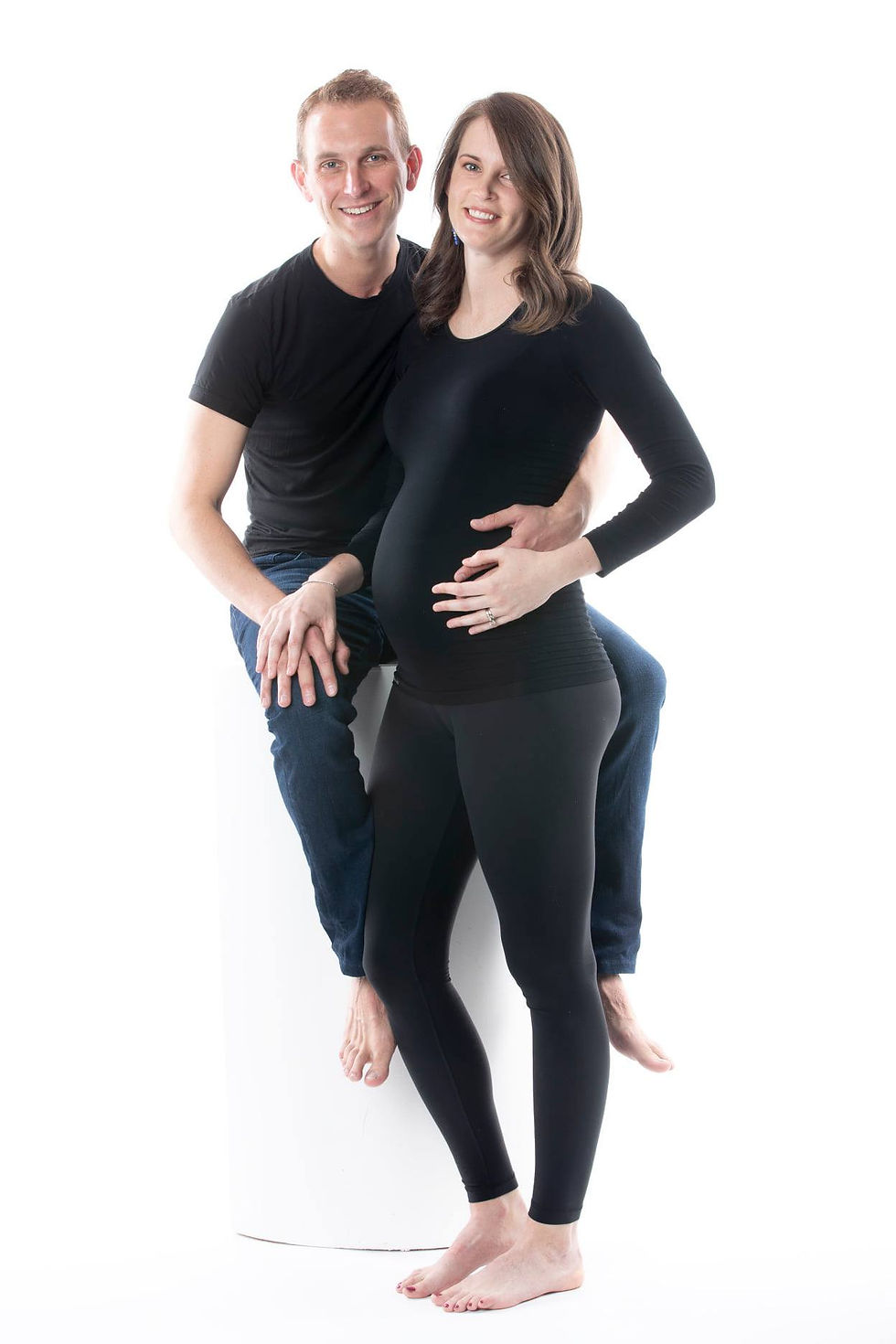 Let Tals Studio capture the beautiful moments and memories of your expanding family! Capture the graceful, wholesome, and meaningful experience of carrying your precious baby for all pregnant mothers at any stage and any trimester. Remember the experience and beauty of carrying your baby with timeless maternity portraits. At Tals Studio, we offer a personalized photography experience focusing on your moments and connection with pregnancy, and your soon-to-be newborn baby. Visit our studio for a beautiful maternity shoot to remember the days leading up to motherhood forever! Photo of woman in hat holding pregnancy bump stomach at photoshoot white backdrop studio for photography