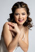 Confident woman posing in studio during affordable glamour shoot.