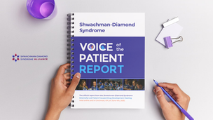 Hands holding a spiral-bound copy of the Shwachman-Diamond Syndrome Voice of the Patient Report, from the Externally-Led Patient Focused Drug Development Meeting held in Cincinnati, OH on June 4th, 2025.
