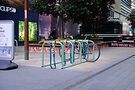 Row of bicycles securely parked in racks – ideal for retrofit smart locks