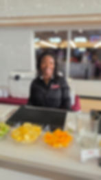 TopShelfTipsy bartender smiling behind the bar during a corporate event in Philadelphia, prepared wi