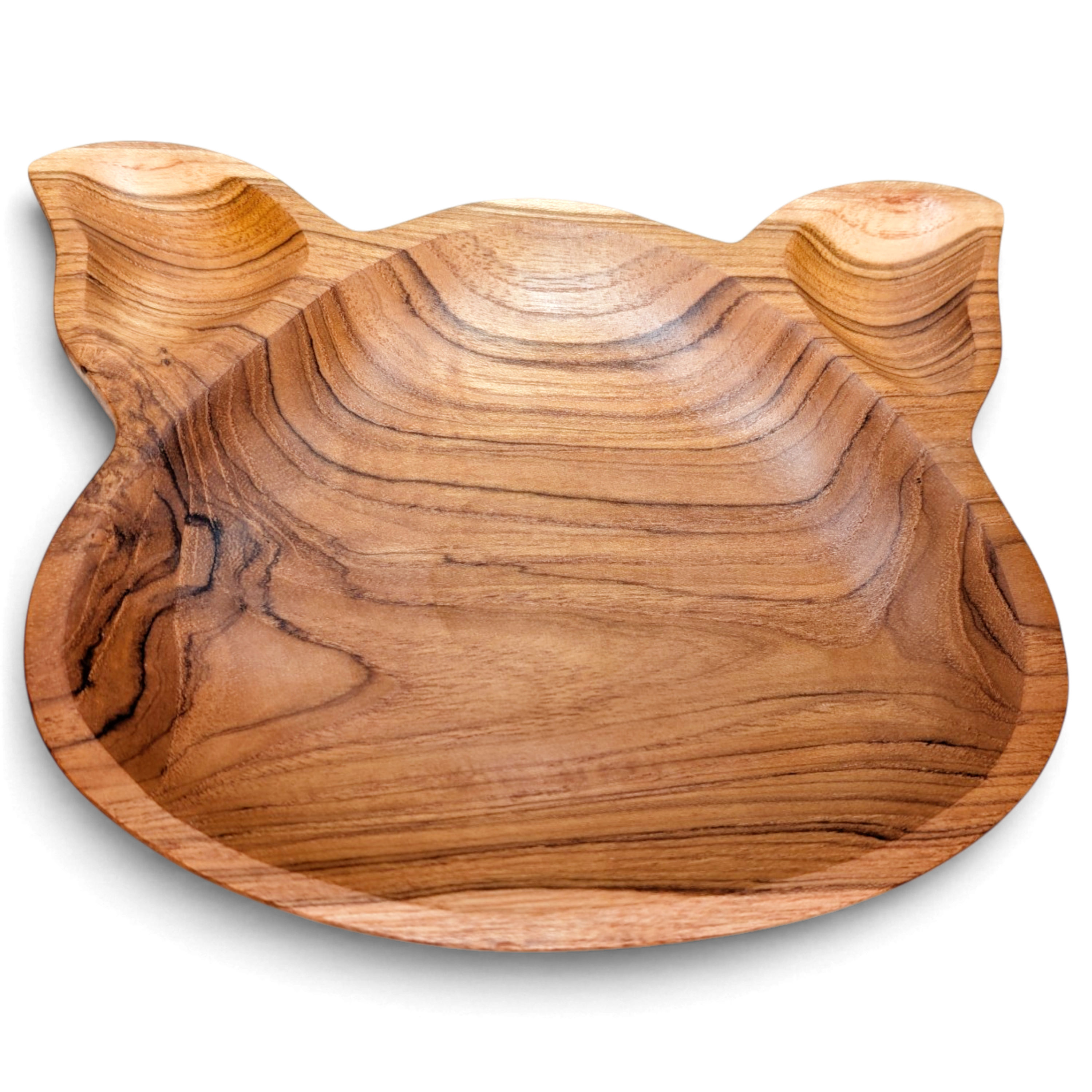 Amber-grain teak pig plate with warm coloring and a playful silhouette
