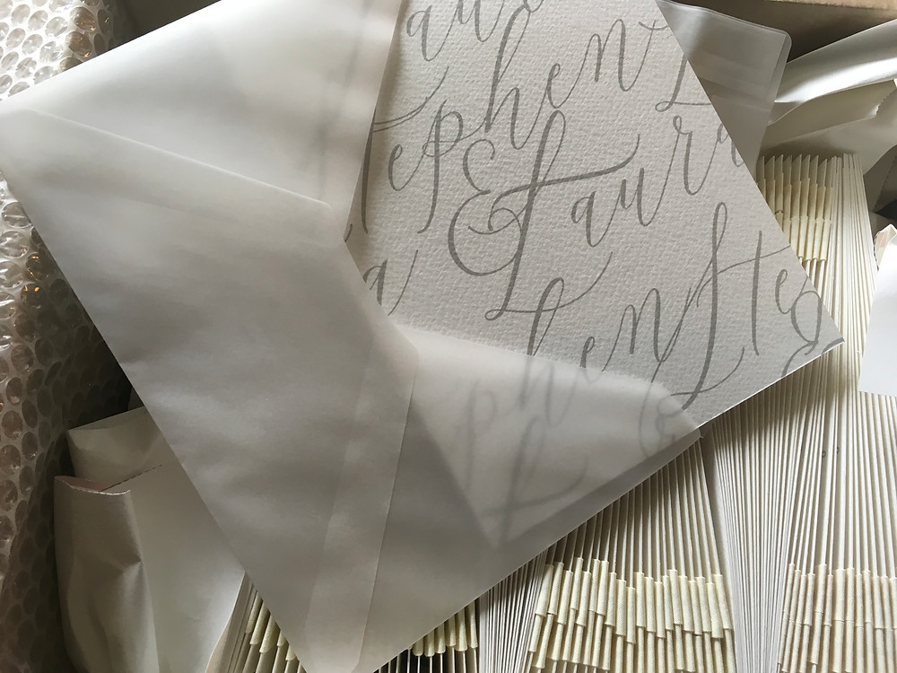 Wedding invitation with vellum envelope, calligraphy, wax seal and ribbon