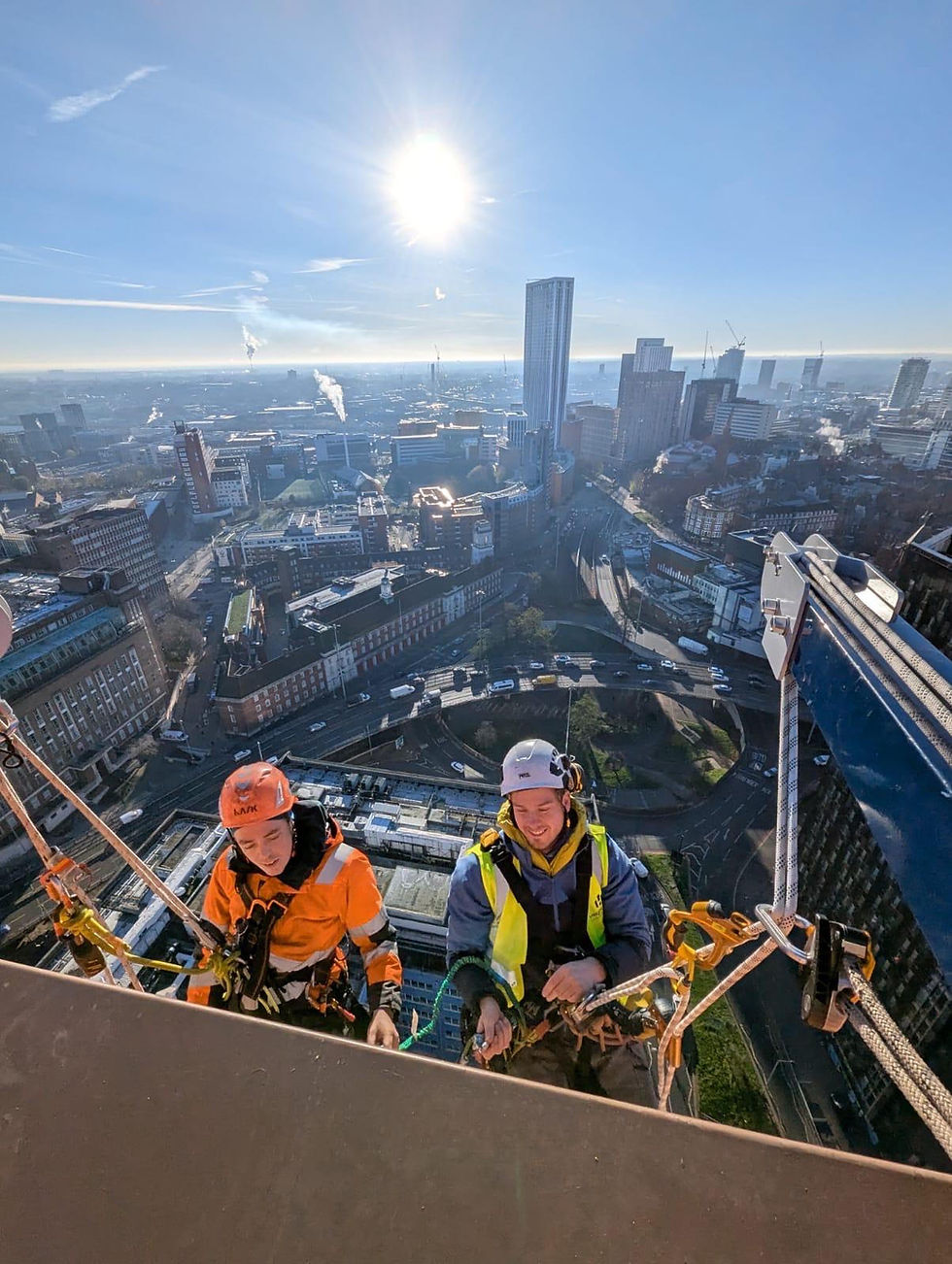 Rope access technicians carrying out a high-level commercial building inspection.