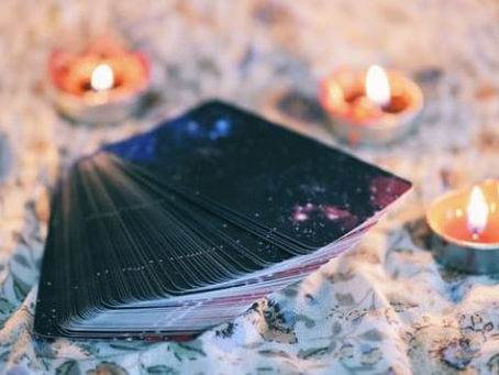 Tarot cards surrounded by tea lights