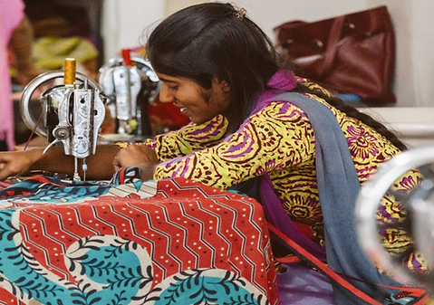 Woman Artisan hand stitching Kantha Throw
