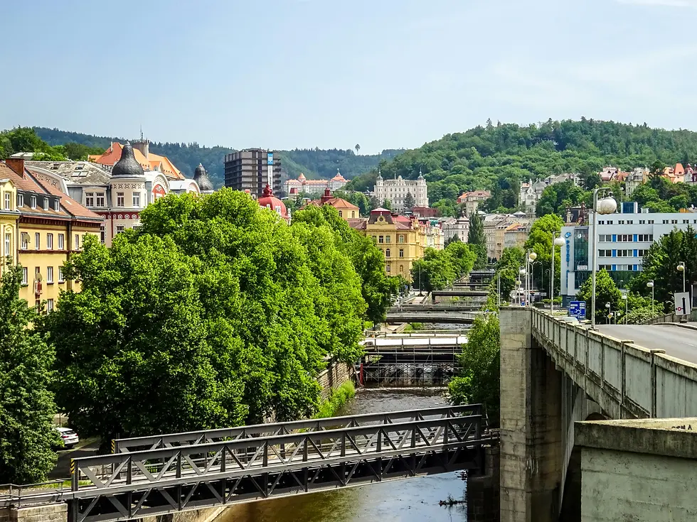 Spa town with a river, footbridges and wooded hills in summer, private jet catering at Karlovy Vary Airport (KLV / LKKV), Karlovy Vary, Czech Republic