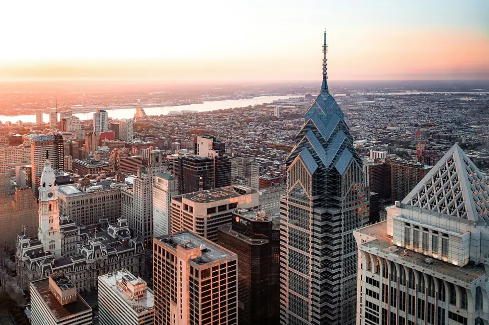 Aerial view of downtown skyscrapers with pointed crowns at sunset beside a river, private jet catering at Philadelphia International Airport (PHL / KPHL), Philadelphia, United States