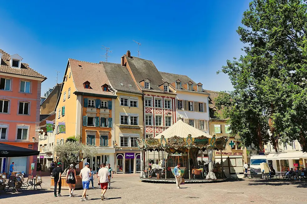Pastel half-timbered buildings and a carousel on a sunny town square, private jet catering at EuroAirport Basel-Mulhouse-Freiburg (BSL / LFSB), Bâle / Mulhouse, France