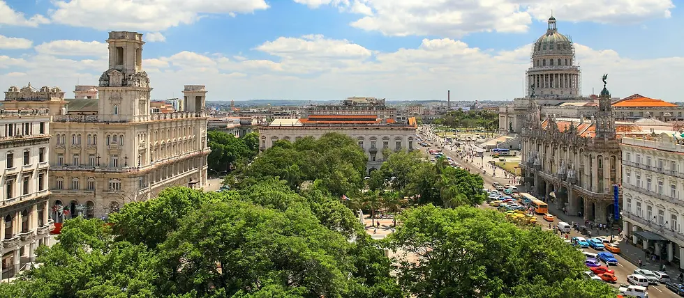 Tree-lined plaza with colonial buildings and a domed capitol seen from above, private jet catering at Abel Santamaría Airport (SNU / MUSC), Santa Clara, Cuba