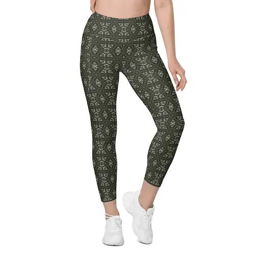 Thumbnail: front view of lady wearing Kaleidoscope leggings with abstract fern and floral shapes in olive and light tones.