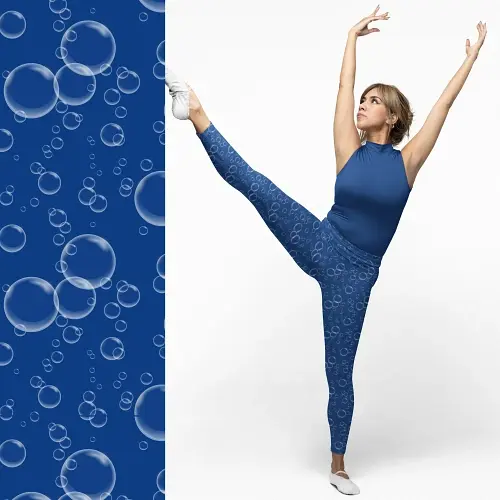 Thumbnail: Woman in Cerulean Blue Bubbles Bright Pattern Leggings lifting one leg high in a ballet-inspired stretch