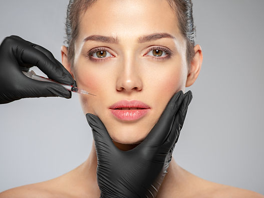 Young caucasian woman getting botox cosmetic injection near the eyes. Beautiful woman gets