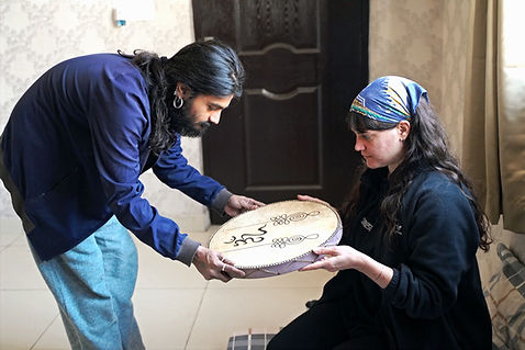 Students learning to play the ocean drum during group sound bath in sound healing teacher training course.