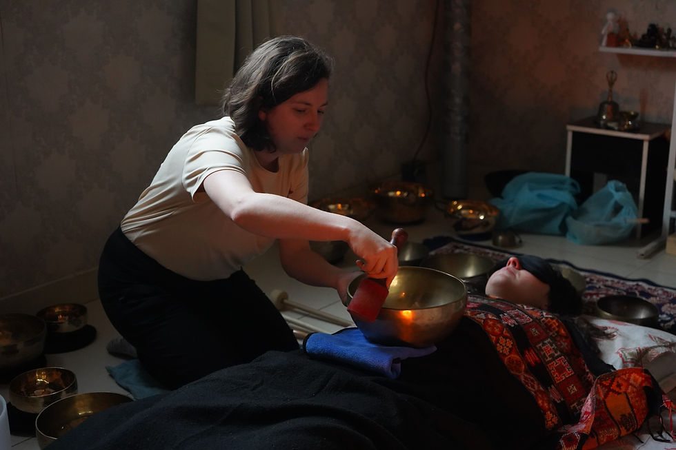 A singing bowl played on the body for chakra frequency healing at Ananda Dhwani, Rishikesh.