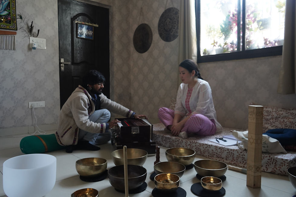 Vocal toning to balance the throat chakra during a sound healing practice in Rishikesh.