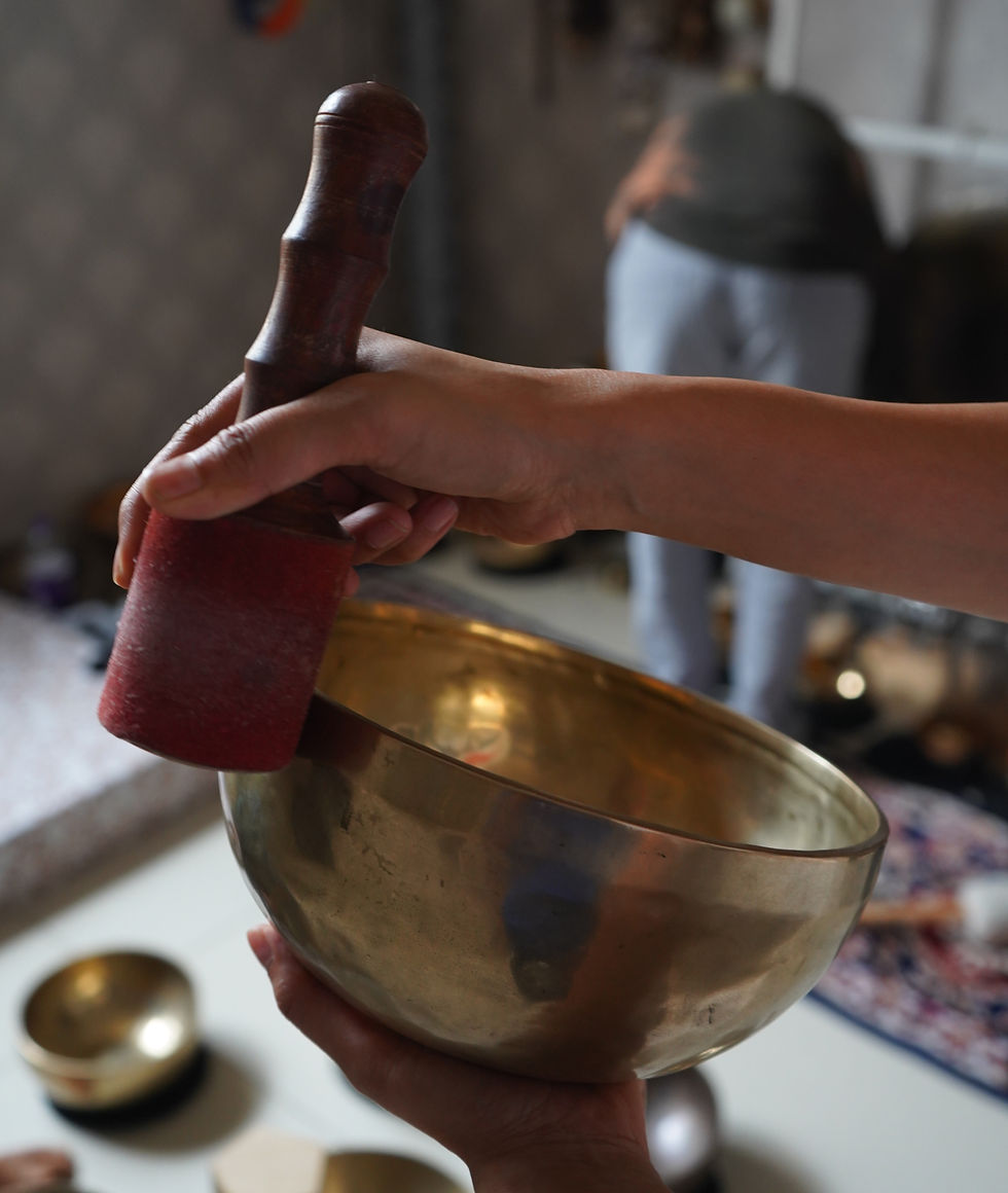Moving through a room with a singing bowl to clear stagnant energy with sound