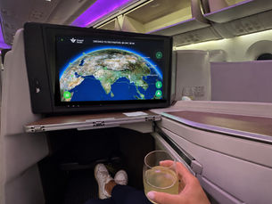 Saudia Business Class review showing a lie-flat seat and in-flight entertainment screen on the Manila to Jeddah flight