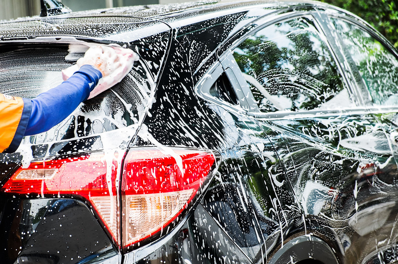 hand hold sponge over the car for washin